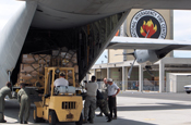 Members of the 146th Aerial Port Squadron of the California Air National Guard load a pallet of boots from the National Interagency Fire Center onto a C-130 aircraft from the 146th Airlift Wing before they are sent to National Guard troops fighting wildfires in California July 5. The 146th AW is conducting firefighting support missions as part of the 302nd Air Expeditionary Group. Photo by Patti Bielling