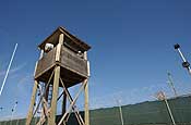 A Soldier with E Company, 629th Military Intelligence Battalion, Maryland Army National Guard, keeps watch from a guard tower at the Joint Task Force Guantanamo detention center at Naval Base Guantanamo Bay, Cuba, Nov. 13, 2006. The company's main missions as part of the task force include perimeter security as well as acting as a quick reaction force should something happen inside the detention center. ( Photo by Staff Sgt. Jon Soucy, National Guard Bureau)