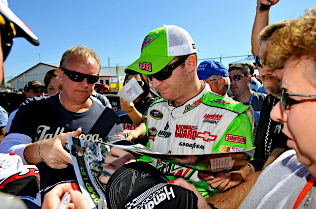 Dale Earnhardt Jr., driver of the No. 88 National Guard racecar, signs autographs for fans before race day at the Talladega Superspeedway in Talladega, Ala. Oct. 15, 2011. (Photo courtesy of Hendrick Motor Sports)(Released)