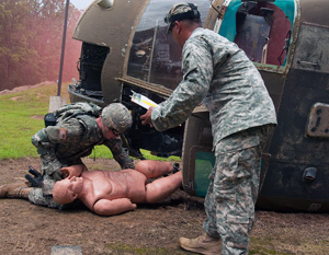 Army Sgt. Corbin D. Routier, an infantryman with the Minnesota Army National Guard's 2nd Combined Arms Battalion, 136th Infantry Regiment, moves a 'casualty' from a simulated downed aircraft  during the 2014 Army National Guard Best Warrior Competition at Camp Joseph T. Robinson, Arkansas, July 14, 2014. Routier is one of 14 competitors in the competition--which tests competitors on a variety of tactical and technical skills in a physically and mentally demanding environment--vying to earn the title of Best Warrior and become the Soldier and Noncommissioned Officer of the Year for the Army Guard. The winners of the competition will go on to represent the Army Guard in the Department of the Army level Best Warrior Competition later this year. (U.S. Army photo by Staff Sgt. Darron Salzer)