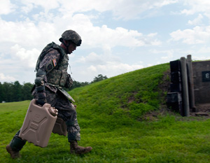 Army Staff Sgt. Cody W. Espinoza, with the Mississippi Army National Guard's 2nd Battalion, 20th Special Forces Group, carries five-gallon water cans through an obstacle course during the 2014 Army National Guard Best Warrior Competition at Camp Joseph T. Robinson, Arkansas, July 14, 2014. Routier is one of 14 competitors in the competition--which tests competitors on a variety of tactical and technical skills in a physically and mentally demanding environment--vying to earn the title of Best Warrior and become the Soldier and Noncommissioned Officer of the Year for the Army Guard. The winners of the competition will go on to represent the Army Guard in the Department of the Army level Best Warrior Competition later this year. (U.S. Army photo by Staff Sgt. Darron Salzer)
