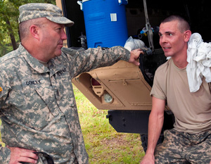 Command Sgt. Maj. Brunk W. Conley, left, command sergeant major of the Army National Guard, talks with Army Sgt. Benjamin T. Stocker, a CH-47 Chinook helicopter repairer with the Colorado Army National Guard's Detachment 1, B Company, 2nd Battalion, 135th Aviation Regiment, during the 2014 Army National Guard Best Warrior Competition at Camp Joseph T. Robinson, Arkansas, July 14, 2014. Espinoza is one of 14 competitors in the competition--which tests competitors on a variety of tactical and technical skills in a physically and mentally demanding environment--vying to earn the title of Best Warrior and become the Soldier and Noncommissioned Officer of the Year for the Army Guard. The winners of the competition will go on to represent the Army Guard in the Department of the Army level Best Warrior Competition later this year. (U.S. Army photo by Staff Sgt. Darron Salzer)
