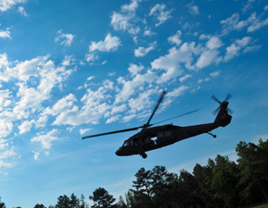 Soldiers competing in the 2014 Army National Guard Best Warrior Competition move toward a UH-60 Blackhawk helicopter to be transported to their next event as part of the competition, July 15, 2014 at Camp Robinson, Ark. The competition tests the 14 competitors on a variety of tactical and technical skills in a physically and mentally exhausting and challenging environment. Those who win will be named the Army Guard Soldier and Noncommissioned Officer of the Year and move on to represent the Army Guard in the Department of the Amry Best Warrior Competition held later this year. (Army National Guard photo by Staff Sgt. Darron Salzer/ Released)