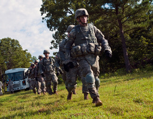 Competitors in the 2014 Army National Guard Best Warrior Competition move out to their next event during the competition at Camp Joseph T. Robinson, Arkansas, July 14, 2014. The competition tests competitors on a variety of tactical and technical skills in a physically and mentally demanding environment as they vie to earn the title of Best Warrior and become the Soldier and Noncommissioned Officer of the Year for the Army Guard. The winners of the competition will go on to represent the Army Guard in the Department of the Army level Best Warrior Competition later this year. (U.S. Army photo by Staff Sgt. Darron Salzer)