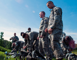 Competitors in the 2014 Army National Guard Best Warrior Competition pack their rucksacks and secure their gear prior to moving out to the next event during the competition at Camp Joseph T. Robinson, Arkansas, July 14, 2014. The competition tests competitors on a variety of tactical and technical skills in a physically and mentally demanding environment as they vie to earn the title of Best Warrior and become the Soldier and Noncommissioned Officer of the Year for the Army Guard. The winners of the competition will go on to represent the Army Guard in the Department of the Army level Best Warrior Competition later this year. (U.S. Army photo by Staff Sgt. Darron Salzer)