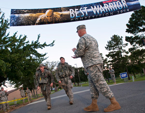 Spc. Ryan Montgomery, left, with the Arkansas Army National Guard, and Sgt. Jacob Weidow, an infantryman with the Pennsylvania Army National Guard's 1st Battalion, 109th Infantry Regiment, cross the finish line after completing the ruck march portion of the 2014 Army National Guard Best Warrior Competition at Camp Joseph T. Robinson, Arkansas, July 16, 2014. The competition tests competitors on a variety of tactical and technical skills in a physically and mentally demanding environment as they vie to earn the title of Best Warrior and become the Soldier and Noncommissioned Officer of the Year for the Army Guard. The winners of the competition will go on to represent the Army Guard in the Department of the Army level Best Warrior Competition later this year. (U.S. Army photo by Staff Sgt. Darron Salzer)