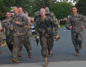 Competitors in 2014 Army National Guard Best Warrior Competition cross the finish line of the ruck march portion of the competition at Camp Joseph T. Robinson, Arkansas, July 16, 2014. The competition tests competitors on a variety of tactical and technical skills in a physically and mentally demanding environment as they vie to earn the title of Best Warrior and become the Soldier and Noncommissioned Officer of the Year for the Army Guard. The winners of the competition will go on to represent the Army Guard in the Department of the Army level Best Warrior Competition later this year. (U.S. Army photo by Staff Sgt. Darron Salzer)