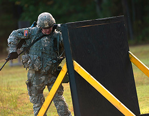 Army Staff Sgt. Devin Jameson Sr., a combat medic with the Utah Army National Guard's 2nd Battalion, 640th Regiment (Regional Training Institute), prepares to scale a short wall at the warrior task and battle drill event at the 2014 Department of the Army Best Warrior Competition, Oct. 7, 2014 at Fort Lee, Va. Jameson represented the Army National Guard as its top noncommissioned officer of the year. (Army National Guard photo by Staff Sgt. Darron Salzer, National Guard Bureau)(Released)