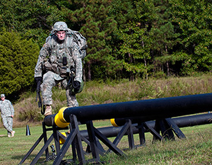 Spc. Ryan Montgomery, an infantryman with the Arkansas National Guard’s 39th Infantry Brigade Combat Team, walks across a balance beam obstacle at the warrior task and battle drill event at the 2014 Department of the Army Best Warrior Competition, Oct. 7, 2014 at Fort Lee, Va. Montgomery represented the Army National Guard as its top enlisted Soldier of the year. (Army National Guard photo by Staff Sgt. Darron Salzer, National Guard Bureau)(Released)