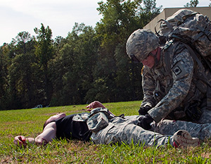 Spc. Ryan Montgomery, an infantryman with the Arkansas National Guard’s 39th Infantry Brigade Combat Team, evaluates a casualty during the warrior task and battle drill event at the 2014 Department of the Army Best Warrior Competition, Oct. 7, 2014 at Fort Lee, Va. Montgomery represented the Army National Guard as its top enlisted Soldier of the year. (Army National Guard photo by Staff Sgt. Darron Salzer, National Guard Bureau)(Released)
