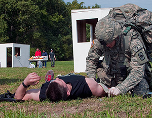 Spc. Ryan Montgomery, an infantryman with the Arkansas National Guard’s 39th Infantry Brigade Combat Team, evaluates a casualty during the warrior task and battle drill event at the 2014 Department of the Army Best Warrior Competition, Oct. 7, 2014 at Fort Lee, Va. Montgomery represented the Army National Guard as its top enlisted Soldier of the year. (Army National Guard photo by Staff Sgt. Darron Salzer, National Guard Bureau)(Released)