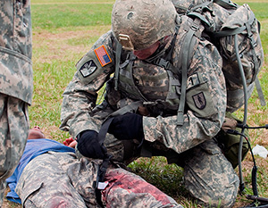 Army Staff Sgt. Devin Jameson Sr., a combat medic with the Utah Army National Guard's 2nd Battalion, 640th Regiment (Regional Training Institute), evaluates a casualty during the warrior task and battle drill event at the 2014 Department of the Army Best Warrior Competition, Oct. 7, 2014 at Fort Lee, Va. Jameson represented the Army National Guard as its top noncommissioned officer of the year. (Army National Guard photo by Staff Sgt. Darron Salzer, National Guard Bureau)(Released)