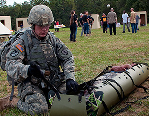 Army Staff Sgt. Devin Jameson Sr., a combat medic with the Utah Army National Guard's 2nd Battalion, 640th Regiment (Regional Training Institute), evaluates a casualty during the warrior task and battle drill event at the 2014 Department of the Army Best Warrior Competition, Oct. 7, 2014 at Fort Lee, Va. Jameson represented the Army National Guard as its top noncommissioned officer of the year. (Army National Guard photo by Staff Sgt. Darron Salzer, National Guard Bureau)(Released)