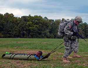 Army Staff Sgt. Devin Jameson Sr., a combat medic with the Utah Army National Guard's 2nd Battalion, 640th Regiment (Regional Training Institute), drags a mock casualty towards a medical evacuation point at the warrior task and battle drill event at the 2014 Department of the Army Best Warrior Competition, Oct. 7, 2014 at Fort Lee, Va. Jameson represented the Army National Guard as its top noncommissioned officer of the year. (Army National Guard photo by Staff Sgt. Darron Salzer, National Guard Bureau)(Released)