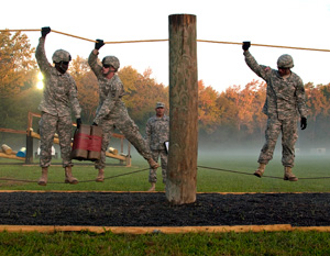 Army Sgt. Ryan Montgomery, center, an infantryman with the Arkansas National Guard’s Company D, 2nd Battalion, 153rd Infantry Regiment, and members of his team navigate the Leadership Reaction Course at the 2014 Department of the Army Best Warrior Competition, Oct. 8, 2014 at Fort Lee, Va. Montgomery represented the Army National Guard as its top enlisted Soldier of the year. (Army National Guard photo by Staff Sgt. Darron Salzer, National Guard Bureau)(Released)