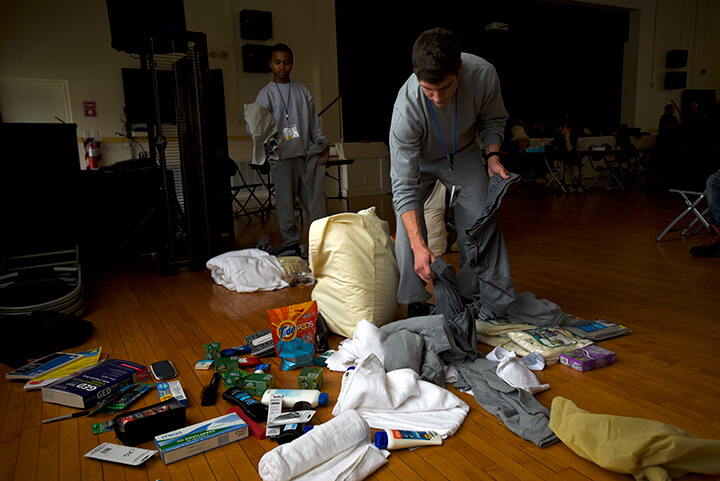 Joshua Griffin and other candidates rummage through their belongings during a shakedown inspection.