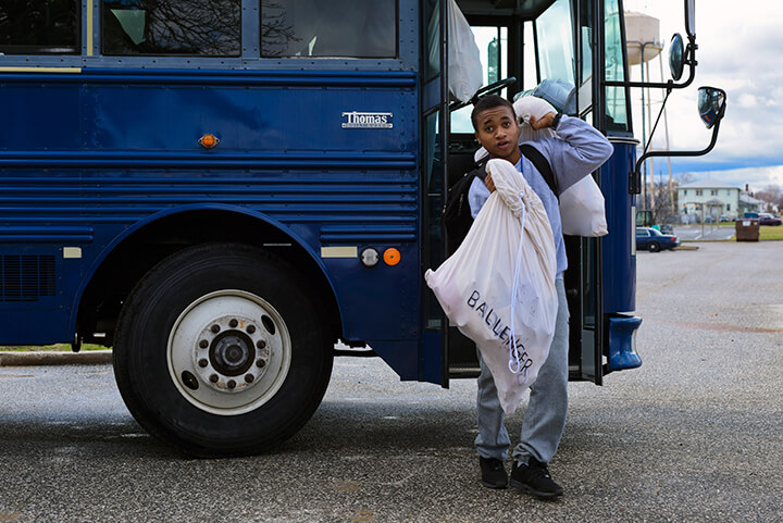 Ricardo Ballenger steps off a bus outside the Freestate Academy.