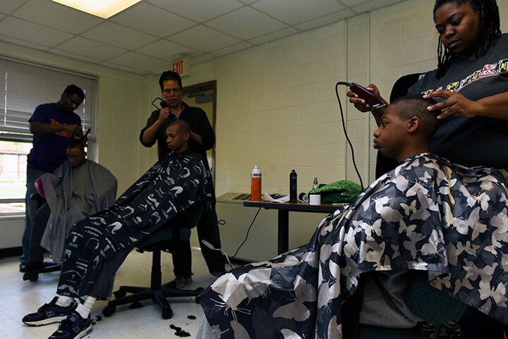 Candidates get new haircuts, one of the first orders of business after arriving at the academy.