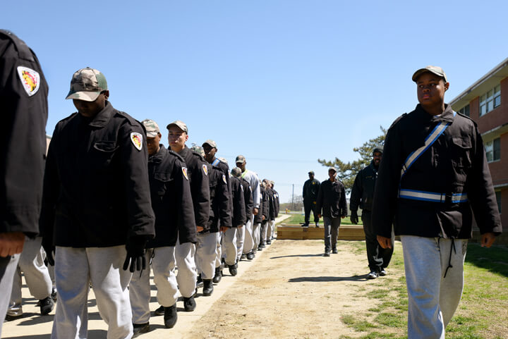 Quinton Worthy tries his hand at marching his platoon as cadre members look on from behind.