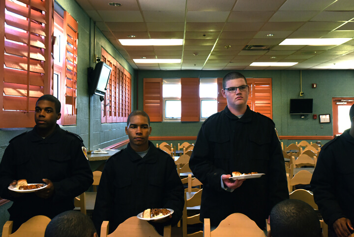 Cadets wait for the signal from cadre to sit and begin lunch in the academy dining facility.