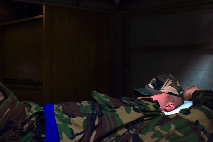 A cadet attempts a few minutes of extra sleep during time allotted for other activities.