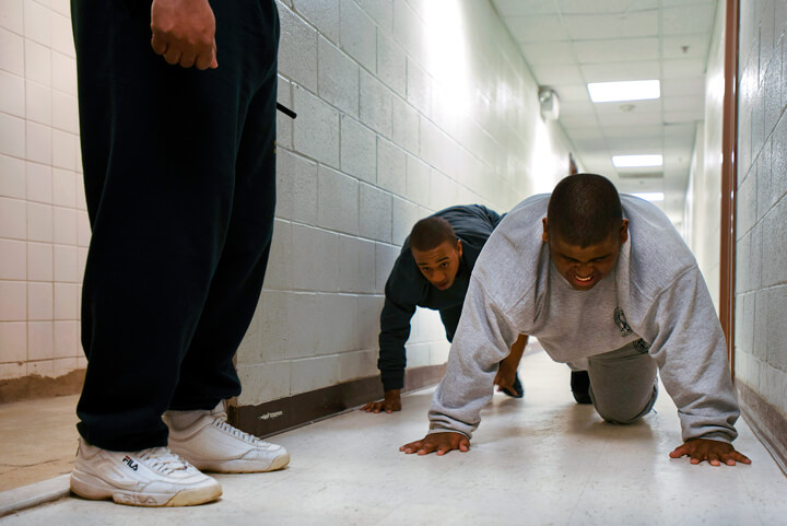 Pushups and 'bear crawls' are the order for Rickaun Morris, center, and Craig Osborne after failure to follow cadre members' instructions