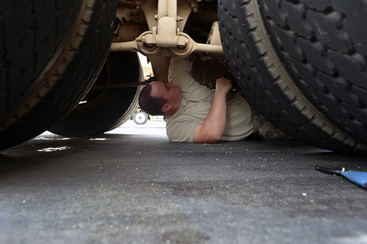 Army Sgt. Richard Johnson replaces a rubber seal on the air brakes of his truck during a fuel stop in South Carolina.