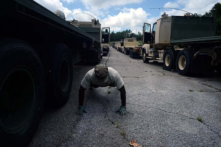 Army Sgt. Charles Wallace takes a break from readying his truck for the convoy.