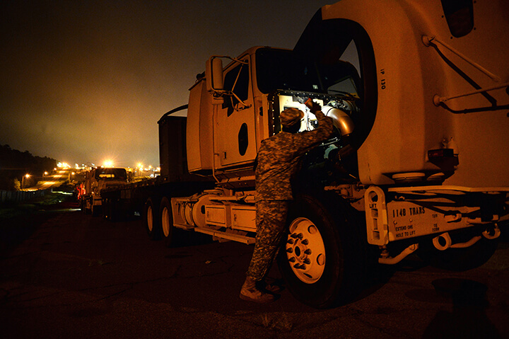 Spc. Craig Elliott performs preventative maintenance checks on his truck prior to heading out.