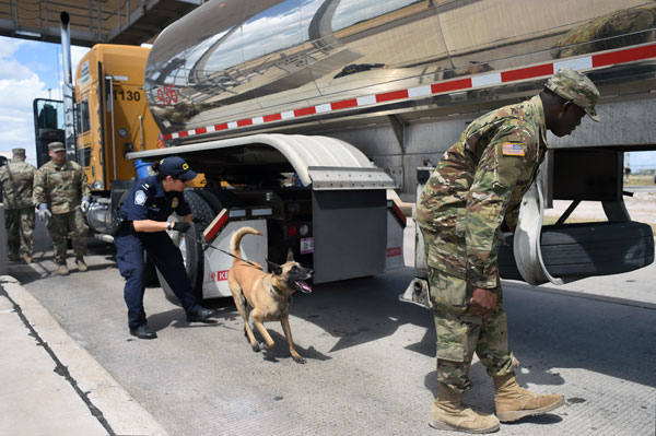 Spc. Afeez Amusan, right, a truck driver with the Texas Army Guard’s Company A, 536th Brigade Support Battalion, inspects a tractor-trailer truck alongside a U.S. Customs and Border Protection agent at CBPs’ Pharr, Texas, port of entry facility. A native of Nigeria, Amusan came to the U.S. to seek greater opportunities and enlisted as a way to “pay the United States of America back for giving me the opportunity to come to the country.”
