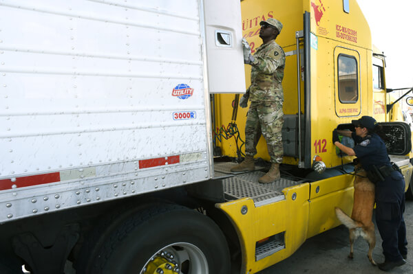 Spc. Isaac Aduhene, a petroleum supply specialist with F Co., 536th BSB, works side-by-side with a CBP officer at the Pharr port of entry.
