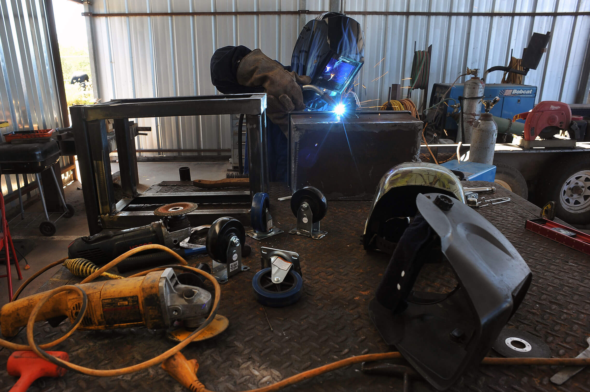 The blue-tinged intensity of the welding gun lights up the masked face of Army Pfc. Ramsey Victor, a combat engineer with the Texas Army National Guard’s Company A, 172nd Brigade Engineer Battalion, as he welds together parts of a distress beacon while on duty at the U.S. Border Patrol facility in McAllen, Texas. Placed in the desert along the Texas-Mexico border, the beacons are a potential lifeline for those who may have crossed the border illegally and find themselves in need of water or medical attention. Activating the beacon summons Border Patrol agents, and help to the area. Guard members have been working in a variety of infrastructure support functions to Border Patrol, including welding and monitoring surveillance cameras in high-traffic border crossing areas.