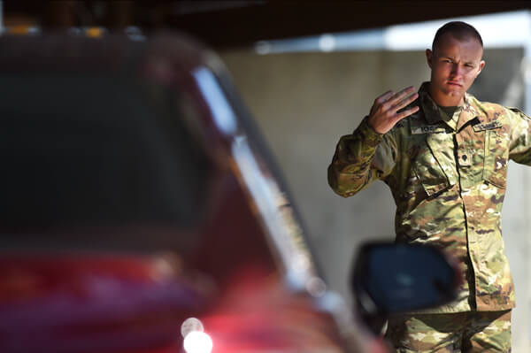 Passenger vehicles get a similar going over as commercial trucks. Spc. Jordan Fons, a mechanic with the Wisconsin Army National Guard's 229th Engineer Company, directs a driver to pull forward in an inspection lane at CBP's Nogales, Ariz., port of entry. After an initial screening by CBP officers, drivers' vehicles are X-rayed. Fons directs drivers through the X-ray lanes, sending them on to a secondary inspection area if needed.