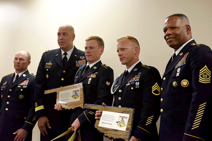 Spc. Hunter Olson, Army Staff Sgt. Erich Friedlein, Army Sgt. Maj. John Sampa, Army Sgt. Maj. Christopher Miller, Army Maj. Gen. Michael Thompson