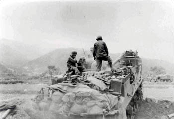 An M-7 Priest of the 213th Armored Field Artillery Battalion firing missions in the spring of 1951