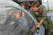 Young American Day - Capt. William Kopp shows the instruments of an F-15 Eagle to a young visitor during Young American Day on Aug. 12 at the Oregon Air National Guard Base in Portland. Captain Kopp is with the 142nd Fighter Wing. (U.S. Air Force photo/Senior Airman John Hughel Jr.)
