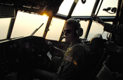 Major Kevin Harkey, assigned to the 145th Airlift Wing of the North Carolina Air National Guard, pilots a C-130 Hercules aircraft equipped with the modular airborne firefighting system to the Lake Shasta area on a firefighting mission July 4. Members of the 145th AW are conducting firefighting operations as a part of the 302nd Air Expeditionary Group.