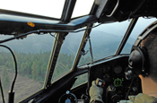 Lieutenant Col. Tim Ashley, assigned to the 145th Airlift Wing of the North Carolina Air National Guard, pilots a C-130 Hercules aircraft equipped with the modular airborne firefighting system to the Lake Shasta area on a firefighting mission July 4. Members of the 145th AW are conducting firefighting operations in California as a part of the 302nd Air Expeditionary Group.