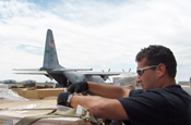 Senior Master Sgt. Ray Roblis, an air transportation specialist assigned to the 146th Aerial Port Squadron of the California Air National Guard, ties down a pallet of boots from the National Interagency Fire Center in Boise, Idaho before they are loaded onto a C-130J aircraft from the 146th Airlift Wing and sent to National Guard troops fighting wildfires in California July 5.