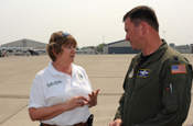 Darlene Mullins, a modular airborne fire fighting system liaison officer for the U.S. Forest Service, discusses upcoming firefighting missions with Lt. Col. Tom Brown, commander of the 145th Air Expeditionary Squadron of the North Carolina Air National Guard. The 145th AES is conducting firefighting missions as part of the 302nd Air Expeditionary Group. Photo by Petty Officer 1st Class Steven J. Weber.