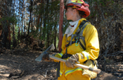 Staff Sgt. Lisa Mirander of Task Force Axe holds a Pulaski, a tool issued to California National Guardsmen on the ground to fight wildfires. (US Army photo by SPC EDDIE SIGUENZA) (Unreleased)