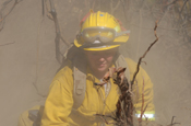 Despite getting consumed by smoke, dirt and raging heat, Spc. Laurel Benghauser of Task Force Axe continues dousing a 