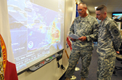Master Sgt. James Kersey (left) and Sgt. 1st Class Chris Brunner of the 53rd Infantry Brigade Combat Team monitor the track of Tropical Storm Isaac from the Florida National Guard's Joint Emergency Operations Center in St. Augustine, Fla., Aug. 22, 2012. The Florida National Guard was monitoring official forecasts for the storm in anticipation of the storm reaching Florida. Photo by Master Sgt. Thomas Kielbasa.