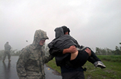 An Airmen from the Louisiana Air National Guard assists local authorities with evacuating residents of Braithwaite, La., in Plaquemines Parish as Hurricane Isaac makes landfall, Aug. 29, 2012. Louisiana Guard members were in place prior to Isaac making landfall and have been assisting local authorities with safety and security throughout the area. (U.S. Army photo by Capt. Lance Cagnolatti)