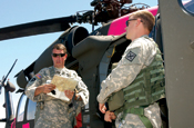 (From left) Chief Warrant Officer 5 Jeff Apke, a UH-60 Blackhawk pilot, conducts a pre-flight briefing wiht Chief Warrant Officer 2 Joel Newburn, also a Blaskhawk pilot, before departing the Mather Flight Facility in northern California July 29 for home. Apke and his fellow crewmembers supported California's firefighting operations since July 14 dropping more than 30,000 gallons of water on the fires. (Photo by Capt. Al Bosco)