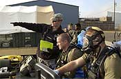  Sgt. Chris Campbell, (left), of the 102nd Civil Support Team, briefs Sgt. Richard Hosmer (center), and Sgt. Paul Edgerly (right), both CST Survey Team Members, at a CST demonstration event at the Marion County Regional Fire Training Facility in Brooks, Ore., on Oct. 27, 2006. Staff Sgt. John Reyes, Survey Team Chief and Sgt 1st Class Sharon Robertson, Logistics NCO, are in the background.