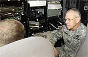 Chief Master Sgt. Shaun Brown, of the 102nd Civil Support Team, (left), briefs Oregon National Guard Adjutant General, Maj. Gen. Raymond F. Rees (right), on the capabilities of the unit's mobile communications vehicle, during a CST demonstration event at the Marion County Regional Fire Training Facility in Brooks, Ore., on Oct. 27, 2006.