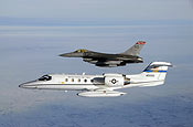 Capt. Stephanie Kelsen pilots a North Dakota Air National Guard F-16 Fighting Falcon alongside the first C-21 to join the 119th Fighter Wing as it flies into Fargo, N.D. Jan. 10. (U.S. Air Force photo/Senior Master Sgt. David Lipp)