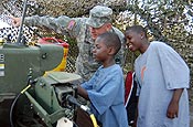  Spc. Nicholas Slover of Bravo Battery, 3rd Battalion, 265th Air Defense Artillery Regiment, lets seven-year-old Nevaun Chamberlain (center) and 11-year-old Joshua Claitt try out the remote control of the Avenger missile system during an exercise at South Lido Key in Sarasota, Fla., May 5, 2007. Photo by Staff Sgt. Thomas Kielbasa.