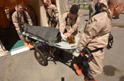 CERF-P team members transport a simulated injured patient, after decontamination, to a field medical treatment facility.
